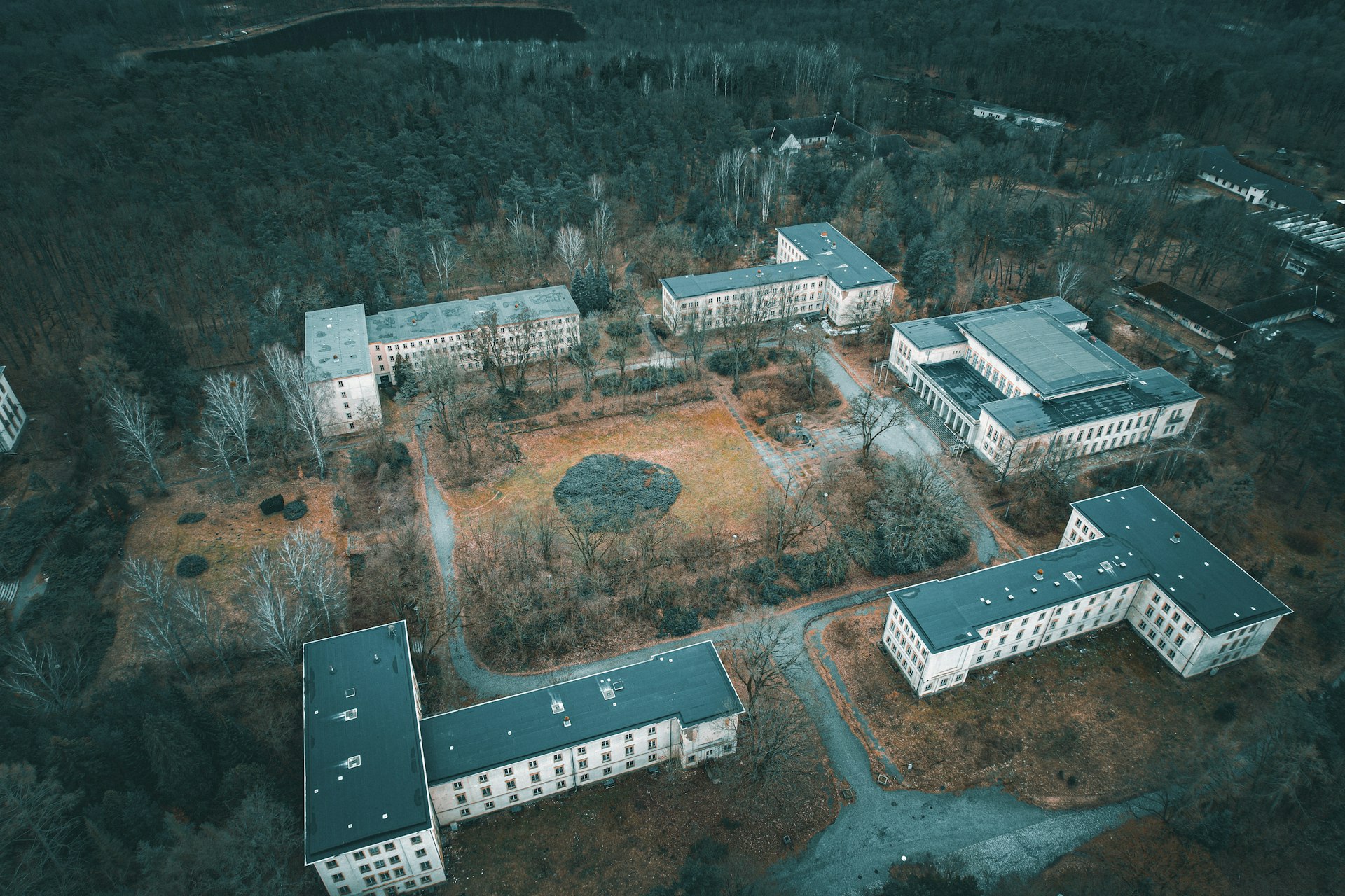 an aerial view of a building surrounded by trees
